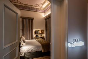 a bedroom with a bed and a coffered ceiling at Palazzo di Sitia Luxury Suites in Sitia