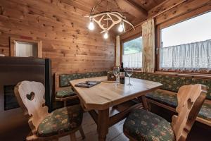 uma sala de jantar com uma mesa e cadeiras num camarote em Holzknechthütte em Mayrhofen