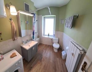 a bathroom with a sink toilet and a window at Gogalova Apartment in Ljubljana