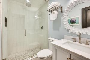 a bathroom with a shower and a toilet and a sink at Crystal River Retreat with Private Dock and Kayaks! in Crystal River +19 photos