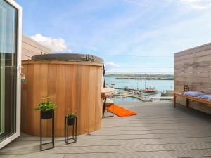 a deck with a hot tub on top of a building at 16 Arwenack Street in Falmouth