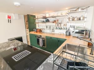 a kitchen with green cabinets and a dishwasher at 16 Arwenack Street in Falmouth