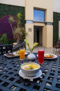 a table with plates of food and drinks on it at Hotel Casino Plaza in Guadalajara
