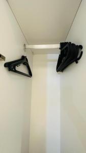 a couple of umbrellas on a shelf in a room at Otel konforunda Lux Residence in Konak