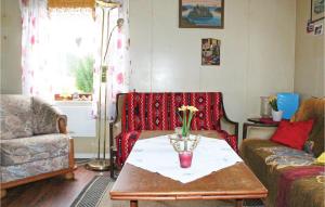 a living room with a table with a vase on it at Amazing Home In Dale I Sunnfjord in Gjølanger