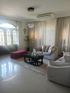 a living room with two couches and a coffee table at Eastern Nights in Cairo