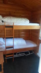 two bunk beds in a cabin with white pillows at Cabin in Trawsfynydd