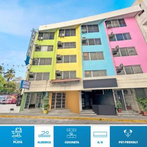 a building with colorfulfacades on a city street at HOTEL Galerias Diana in Acapulco