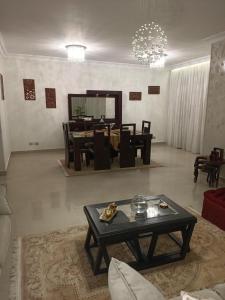 a living room with a table and a dining room at Eastern Nights in Cairo