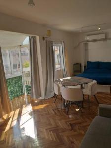 布宜諾斯艾利斯的住宿－Monoambiente Palermo temporario，客厅配有蓝色的沙发和桌子