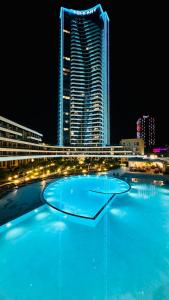 a large pool of blue water in front of a tall building at Luxury residence with sea view in Konak