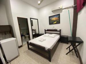 Postel nebo postele na pokoji v ubytování Hotel Malecon Puerto Berrio