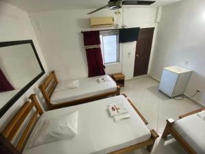 Postel nebo postele na pokoji v ubytování Hotel Malecon Puerto Berrio