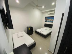 Postel nebo postele na pokoji v ubytování Hotel Malecon Puerto Berrio
