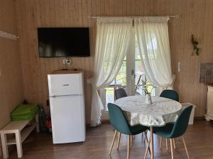 a dining room with a table and chairs and a television at Villa Vita in Seimėnai