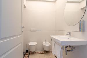 a white bathroom with a sink and a toilet at VILLA ACTEA in Vasto