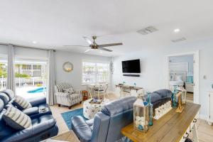 a living room with blue couches and a tv at Sunny Bank in Marathon
