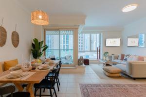 una sala da pranzo e un soggiorno con tavolo da pranzo di LUXFolio Retreats - Astonishing 3BHk Apartment a Dubai