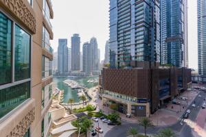 a view of a city with tall buildings and a river at LUXFolio Retreats - Astonishing 3BHk Apartment in Dubai