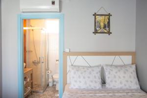 a bedroom with a bed with two pillows and a bathroom at Çeşme Flowers Hotel in Ildır +138 photos