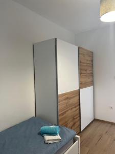 a bedroom with a bed with two wardrobes at Apartment CReO Loborika in Marčana