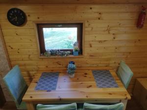 a wooden table in a room with a window at Peace Creek in Slunj