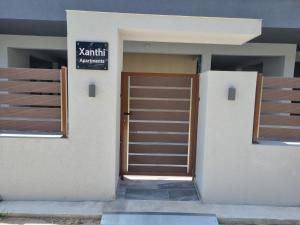 a door to a building with a sign on it at Xanthi Apartments in Katerini