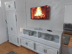a living room with a fireplace on the wall at Studio Aleksandar in Novi Pazar