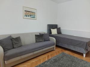 a living room with a couch and a bed at Studio Aleksandar in Novi Pazar
