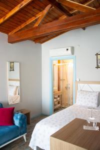 a bedroom with a bed and a blue couch at Çeşme Flowers Hotel in Ildır