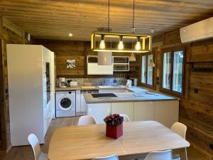 a kitchen with a table and a kitchen with wooden walls at Le cerf majestueux, Bolquere in Bolquere Pyrenees 2000