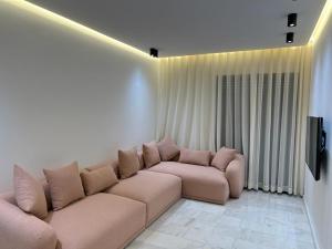 a living room with a couch and a television at Prada appartement Essaouira in Essaouira +11 photos