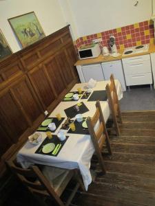 a kitchen with a table and chairs and a kitchen with at Chambres d'hôtes Le Patio d'Alain et Véronique Lunéville in Lunéville