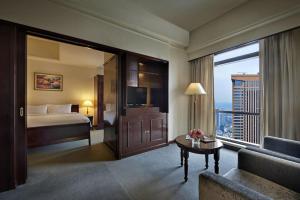 a hotel room with a bed and a large window at Times Square Service Apartment , Kuala Lumpur in Kuala Lumpur