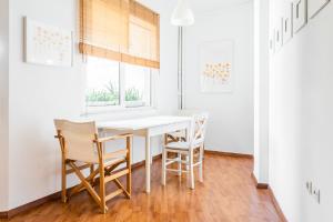 a dining room with a white table and chairs at Beautiful Studio - Heart of Athens in Athens
