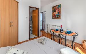 a living room with a table and a bed at Nice Apartment In Rijeka With House Sea View in Rijeka