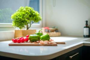 a cutting board filled with vegetables on a kitchen counter at Canon Craig, Luxurious Lakeland stone Cottage in Bowness-on-Windermere