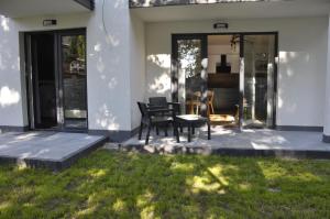 a house with a patio with a table and chairs at morze i plaża in Łeba