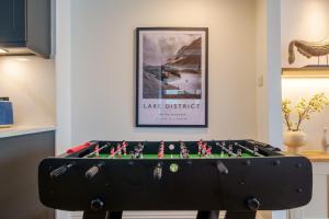 a pool table in a room with a picture at Canon Craig, Luxurious Lakeland stone Cottage in Bowness-on-Windermere