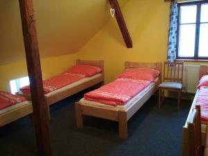 a room with three bunk beds and a window at Horská chata Boubelka in Pec pod Sněžkou