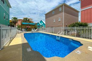 a swimming pool in a yard next to a house at The Yellow Rose in Gulf Shores