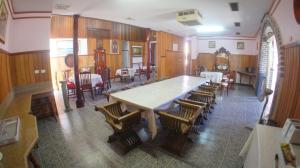 a dining room with a large table and chairs at A Railway Lodge in Taree