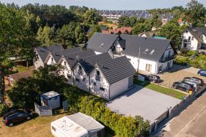 an aerial view of a house with a garage at Natura Jantar - Całoroczne domy drewniane in Jantar