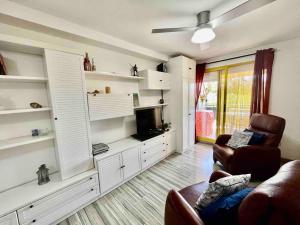 a living room with white shelves and a couch at Evinrude 2 in Sant Carles de la Ràpita