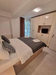 a bedroom with a large bed in a room at Close to the Airport 15 minutes walk & Therme -SELF CHECK-IN in Otopeni