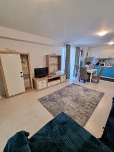 a living room with a kitchen and a dining room at Close to the Airport 15 minutes walk & Therme -SELF CHECK-IN in Otopeni