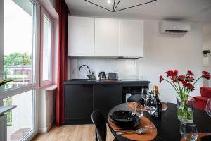 a kitchen with a table and a dining room at FLATMORE Apartament Długa 8m6 in Zielona Góra