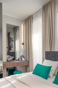 a bedroom with a bed and a desk and a mirror at Upper Premium Apartments in Rijeka