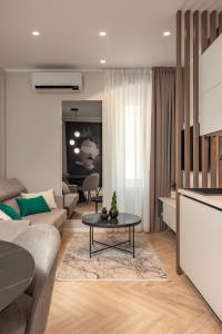 a living room with a couch and a table at Upper Premium Apartments in Rijeka