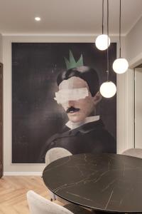 a painting of a man with a green leaf on his head at Upper Premium Apartments in Rijeka
